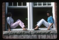 Students sitting outside of a window